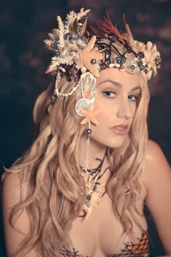 Fantasy portrait of a woman wearing an elaborate mermaid-themed headdress with shells and starfish