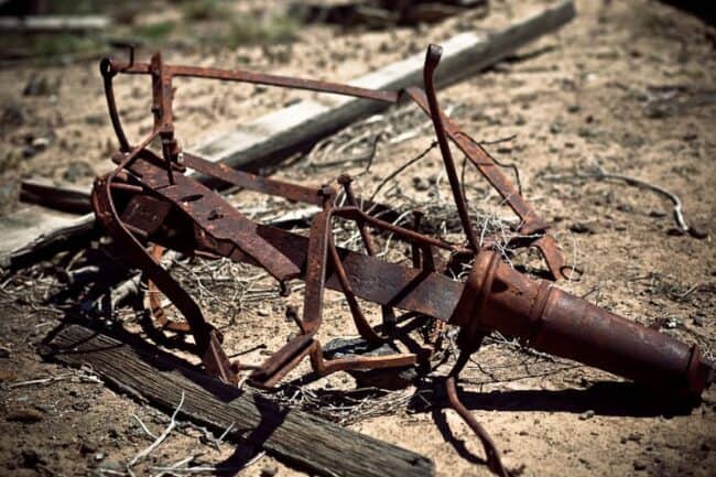 Rusted antique farm equipment abandoned on the ground in eastern Oregon