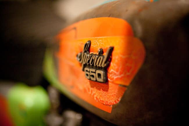 Close-up of an orange motorcycle fuel tank badge reading Special 650