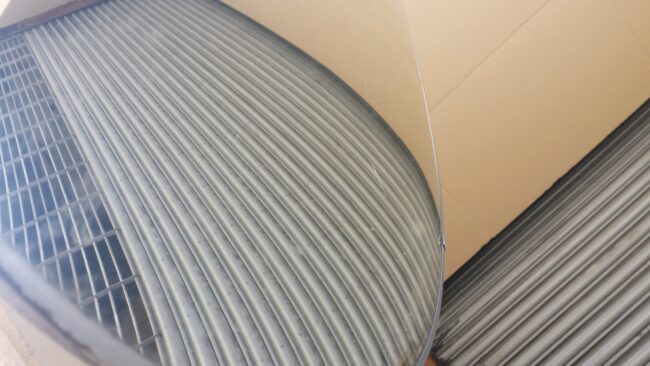 Close-up of curved corrugated metal roofing panels