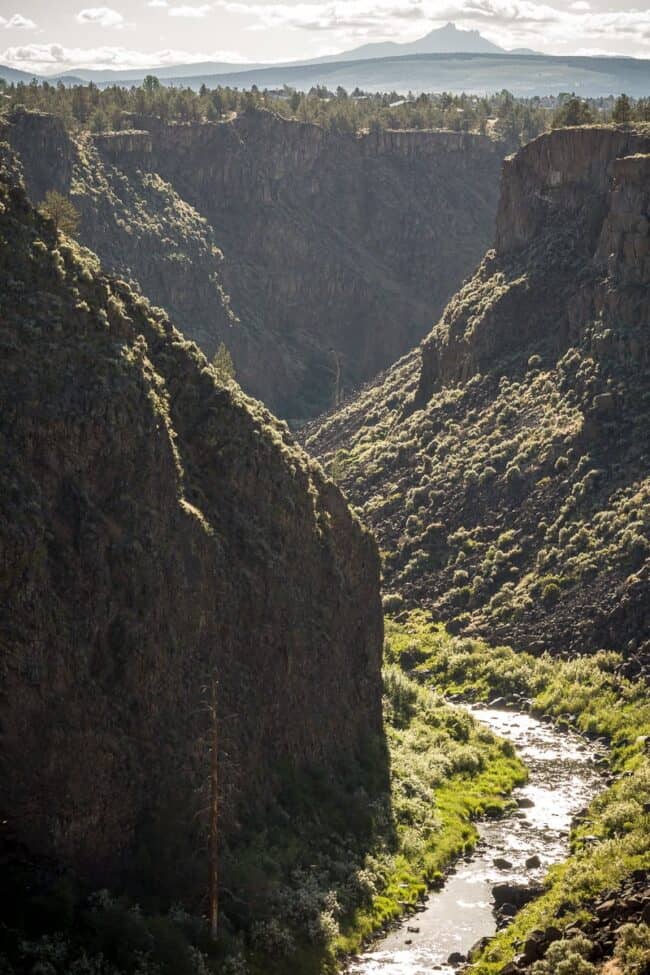 Aerial view of a deep river canyon with a stream running through steep rocky cliffs