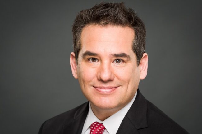 Professional headshot portrait of Wayne Garcia for KPTV against a gray studio backdrop