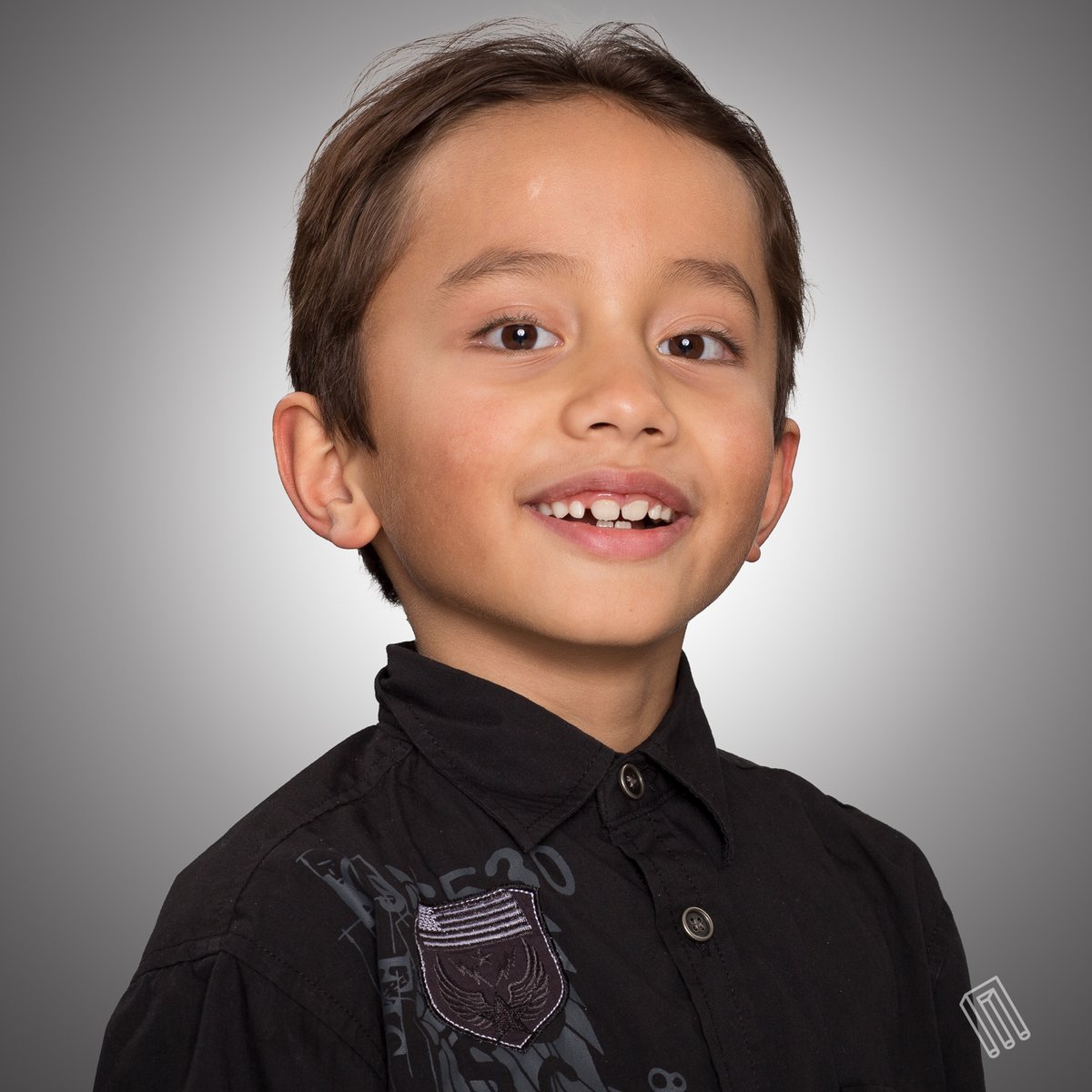 Young boy with dark hair, black shirt, color