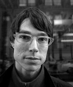 Black and white portrait of a young man with glasses
