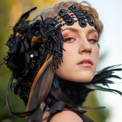 Three-panel triptych of a ballerina in a black tutu with a dark feathered headpiece, dancing en pointe against a weathered wood-plank backdrop