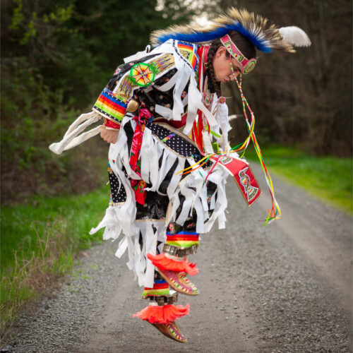 Three-panel triptych of a man in traditional Native American powwow regalia with a feathered headdress, shown in close-up portrait, mid-dance, and standing on a city street